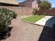Secluded backyard with drought-resistant landscaping and small grassy area at 3736 Gallowtree Ave, North Las Vegas, NV 89081