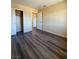 Well-lit bedroom featuring wood floors, closet space, and a neutral color palette at 3736 Gallowtree Ave, North Las Vegas, NV 89081