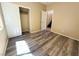 Comfortable bedroom with wood-look flooring, closet, and access to a hallway and stairs at 3736 Gallowtree Ave, North Las Vegas, NV 89081