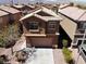 Aerial view of a two-story home featuring a neutral color palette, a tile roof, and a two-car garage at 3736 Gallowtree Ave, North Las Vegas, NV 89081