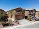 Two-story home featuring a neutral color palette, a tile roof, a two-car garage, and mature landscaping at 3736 Gallowtree Ave, North Las Vegas, NV 89081