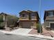 Attractive two-story home with a two-car garage, desert landscaping and tan stucco exterior at 3736 Gallowtree Ave, North Las Vegas, NV 89081