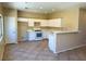 Bright kitchen with white cabinets, modern appliances, breakfast bar, and tiled flooring at 3736 Gallowtree Ave, North Las Vegas, NV 89081