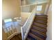 Staircase featuring wood steps and white railings, leading to an open living area below at 3736 Gallowtree Ave, North Las Vegas, NV 89081