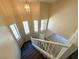 Bright staircase features wood stairs, white railings, and multiple windows, offering natural light at 3736 Gallowtree Ave, North Las Vegas, NV 89081
