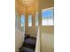 Staircase with dark wood steps and white railings, illuminated by natural light from multiple windows at 3736 Gallowtree Ave, North Las Vegas, NV 89081