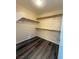 Spacious walk-in closet with built-in shelving and vinyl plank floors at 3736 Gallowtree Ave, North Las Vegas, NV 89081