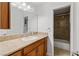 Bathroom featuring granite counters, wood cabinets, and a large mirror at 3769 Fairlawn Ave, Las Vegas, NV 89121