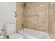 Updated bathroom features tiled shower/tub combo and modern fixtures at 3769 Fairlawn Ave, Las Vegas, NV 89121