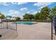 Community pool surrounded by a fence and landscaped with trees at 3769 Fairlawn Ave, Las Vegas, NV 89121