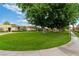 Lush green lawn with mature trees and a path at 3769 Fairlawn Ave, Las Vegas, NV 89121