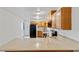 Well-lit kitchen boasts granite counters, wood cabinets, and a neutral backsplash at 3769 Fairlawn Ave, Las Vegas, NV 89121