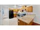 Bright kitchen features wood cabinets, granite counters, and black appliances at 3769 Fairlawn Ave, Las Vegas, NV 89121