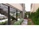 Modern home exterior features a landscaped walkway, large windows, a glimpse of an open kitchen and stairwell at 3961 Heron Fairway Dr, Las Vegas, NV 89141