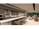Modern kitchen featuring a long island with barstool seating, an open floorplan, and sleek, minimalist design at 3961 Heron Fairway Dr, Las Vegas, NV 89141