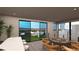 Upstairs living room with a view of the patio and mountains from the balcony with modern seating at 3961 Heron Fairway Dr, Las Vegas, NV 89141