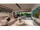 Bright, modern living room with a large sliding glass door to the patio, a marble fireplace and a plush couch at 3961 Heron Fairway Dr, Las Vegas, NV 89141