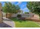 Backyard featuring lush lawn, brick pavers, mature trees, hot tub and stone accents at 4415 Peaceful Harbor St, Las Vegas, NV 89129