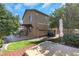 Backyard featuring lush lawn, brick pavers, mature trees, patio, and hot tub at 4415 Peaceful Harbor St, Las Vegas, NV 89129