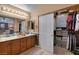 Bathroom with dual sinks, a stone-accented shower, and plenty of storage space at 4415 Peaceful Harbor St, Las Vegas, NV 89129