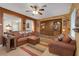 Warm living room with a ceiling fan, built in cabinets, and tile floors at 4415 Peaceful Harbor St, Las Vegas, NV 89129
