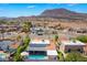 View of home with a sparkling pool, covered patio and a mountain backdrop at 444 Viewmont Dr, Henderson, NV 89015