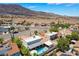 Aerial view shows the pool and patio area along with desert landscaping at 444 Viewmont Dr, Henderson, NV 89015