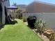 Well-maintained backyard with artificial turf, grill, desert landscaping, and mountain views at 444 Viewmont Dr, Henderson, NV 89015