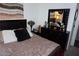 Comfortable bedroom featuring a plush bed, dresser, and decorative lighting at 444 Viewmont Dr, Henderson, NV 89015
