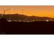 Scenic evening cityscape view with the mountains, city lights, and a vivid sunset backdrop at 444 Viewmont Dr, Henderson, NV 89015