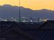 Stunning city views beneath majestic mountains at dusk seen from the rooftop at 444 Viewmont Dr, Henderson, NV 89015