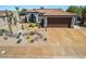 Inviting single-story home with a tile roof, desert landscaping, and a spacious driveway at 444 Viewmont Dr, Henderson, NV 89015