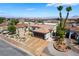 Aerial front view of well-maintained home with desert landscaping and a two car garage at 444 Viewmont Dr, Henderson, NV 89015