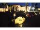 Nighttime view of home with landscape lighting accentuating desert landscaping and a Spanish-tile roof at 444 Viewmont Dr, Henderson, NV 89015