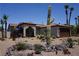 Southwest style home with desert landscaping, including cacti and rock features, plus a brown garage door at 444 Viewmont Dr, Henderson, NV 89015