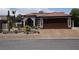 Desert-style home with stone details, a Spanish-tile roof, and a two-car brown garage door at 444 Viewmont Dr, Henderson, NV 89015