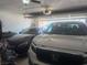 Spacious garage interior featuring two cars and an open garage door at 444 Viewmont Dr, Henderson, NV 89015