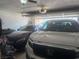 Spacious garage interior featuring two cars and an open garage door at 444 Viewmont Dr, Henderson, NV 89015