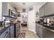 Efficient kitchen design with stainless steel appliances, tiled backsplash, and breakfast bar at 444 Viewmont Dr, Henderson, NV 89015