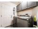 Modern laundry room featuring updated machines and ample storage space at 444 Viewmont Dr, Henderson, NV 89015