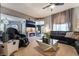 Elegant living room featuring a modern fireplace and a comfortable black leather sofa at 444 Viewmont Dr, Henderson, NV 89015