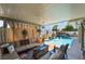 Covered outdoor living space with a view of the pool, and comfortable seating at 444 Viewmont Dr, Henderson, NV 89015
