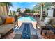 Relaxing outdoor space with a beautiful pool, patio seating, and fire pit, perfect for entertaining guests at 444 Viewmont Dr, Henderson, NV 89015