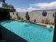 Sparkling swimming pool with desert landscaping, and decorative wall art, creating a backyard oasis at 444 Viewmont Dr, Henderson, NV 89015