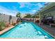 Inviting pool area with a covered patio, complete with outdoor furniture and lush landscaping at 444 Viewmont Dr, Henderson, NV 89015