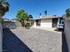 The backyard includes a gravel area with some trees and is surrounded by block walls at 4509 Bingham Ave, Las Vegas, NV 89110