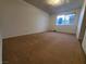 Bedroom featuring neutral carpet and a large window providing natural light at 4509 Bingham Ave, Las Vegas, NV 89110
