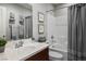 Clean bathroom featuring a shower-tub combo with gray accent curtains and a modern single-sink vanity at 51 Morning Mimosa Ct, Henderson, NV 89012