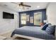 Comfortable bedroom with a ceiling fan, plenty of natural light, and a wall-mounted television at 51 Morning Mimosa Ct, Henderson, NV 89012