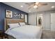 This bedroom boasts an ensuite walk-in closet and a ceiling fan for comfort at 51 Morning Mimosa Ct, Henderson, NV 89012